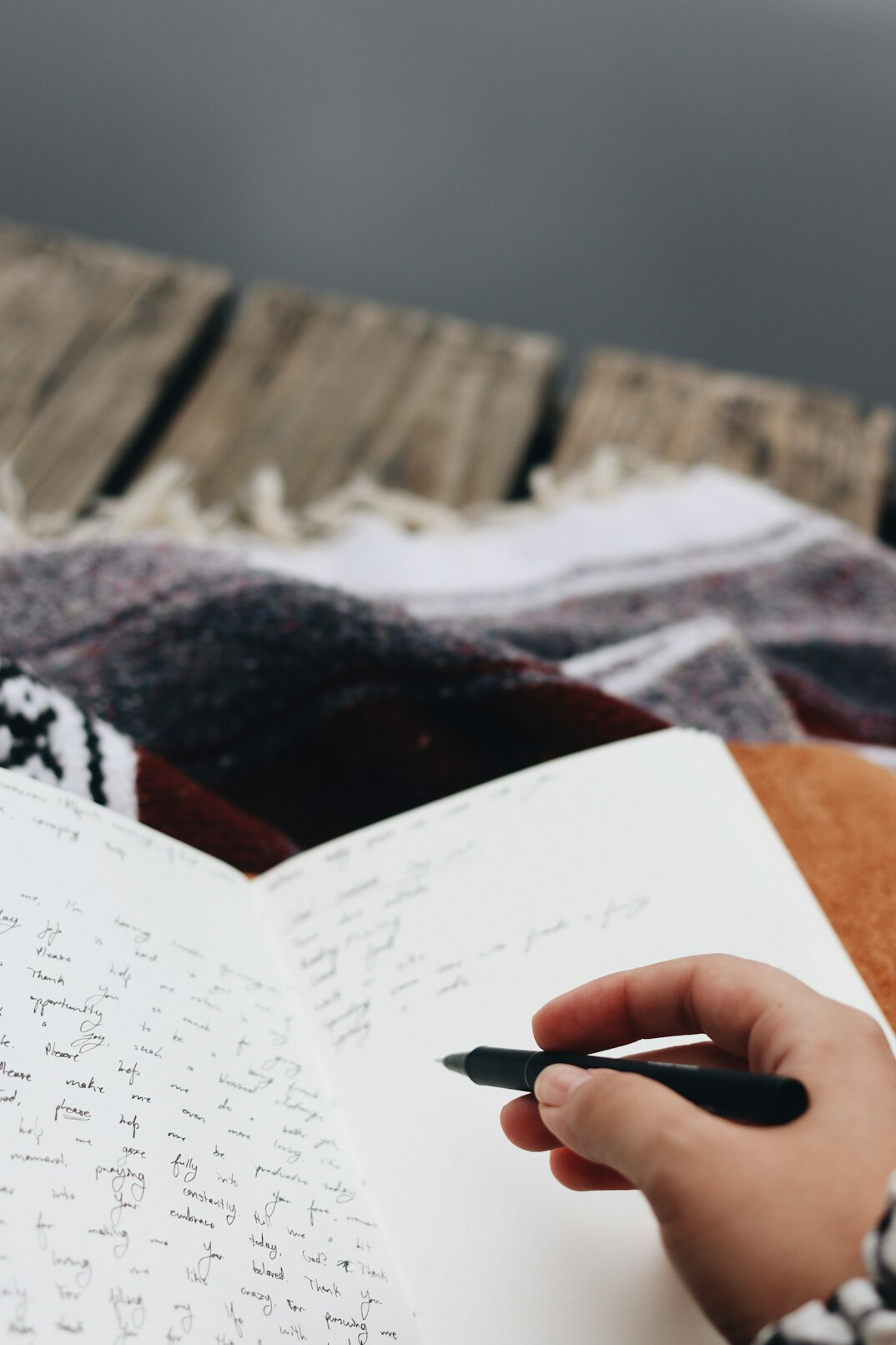 person writing in journal